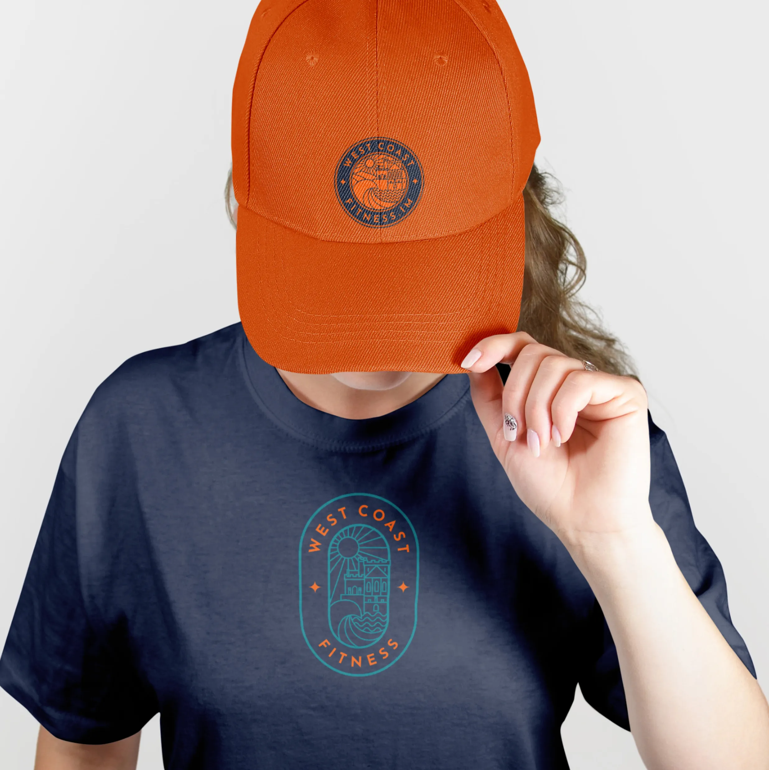 West Coast Fitness branded cap and t-shirt featuring the logo designed by DotPerformance for the Peel fitness centre on the Isle of Man